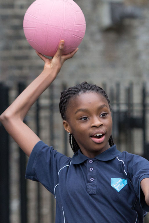 Girl ready to pass a netball in a practice session