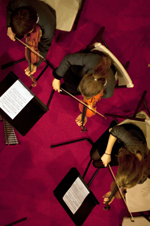 Violinists viewed from above at a concert